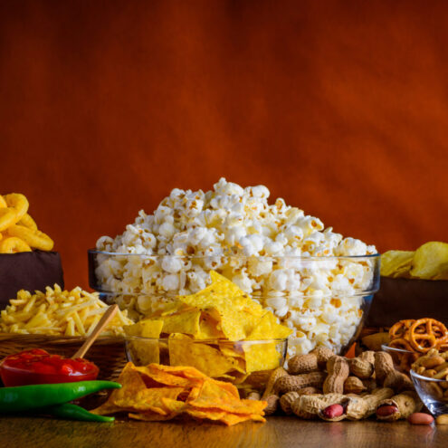 Panoramic still life with salty-snacks, potato-chips, popcorn and dip